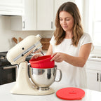 Woman placing a red silicone liner into a stainless steel stand mixer bowl