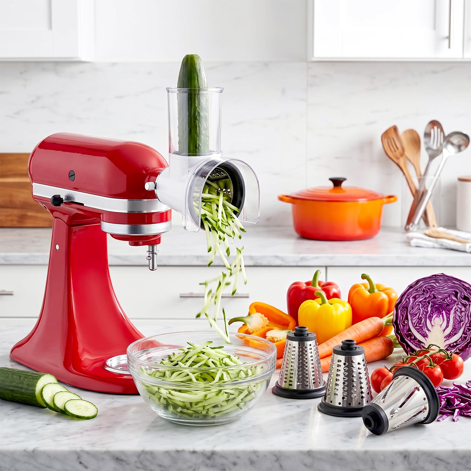 Gvode slicer-shredder processing cucumber on red stand mixer beside four cutting cones