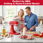 Couple feeding steak through Gvode tenderizer attachment on red stand mixer