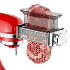 Gvode meat tenderizer attachment on red stand mixer tenderizing a thick cut of meat