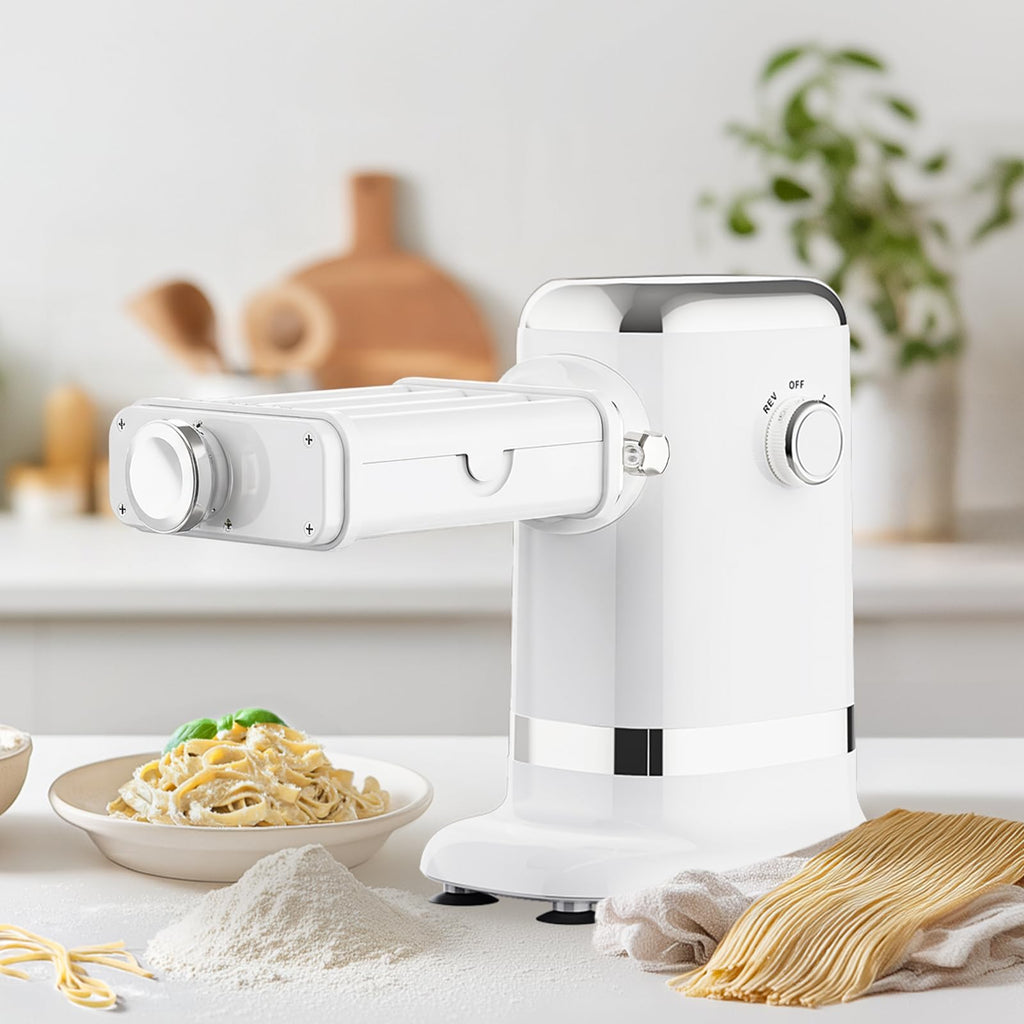 White Gvode electric pasta maker on counter beside a plate of noodles and uncooked pasta